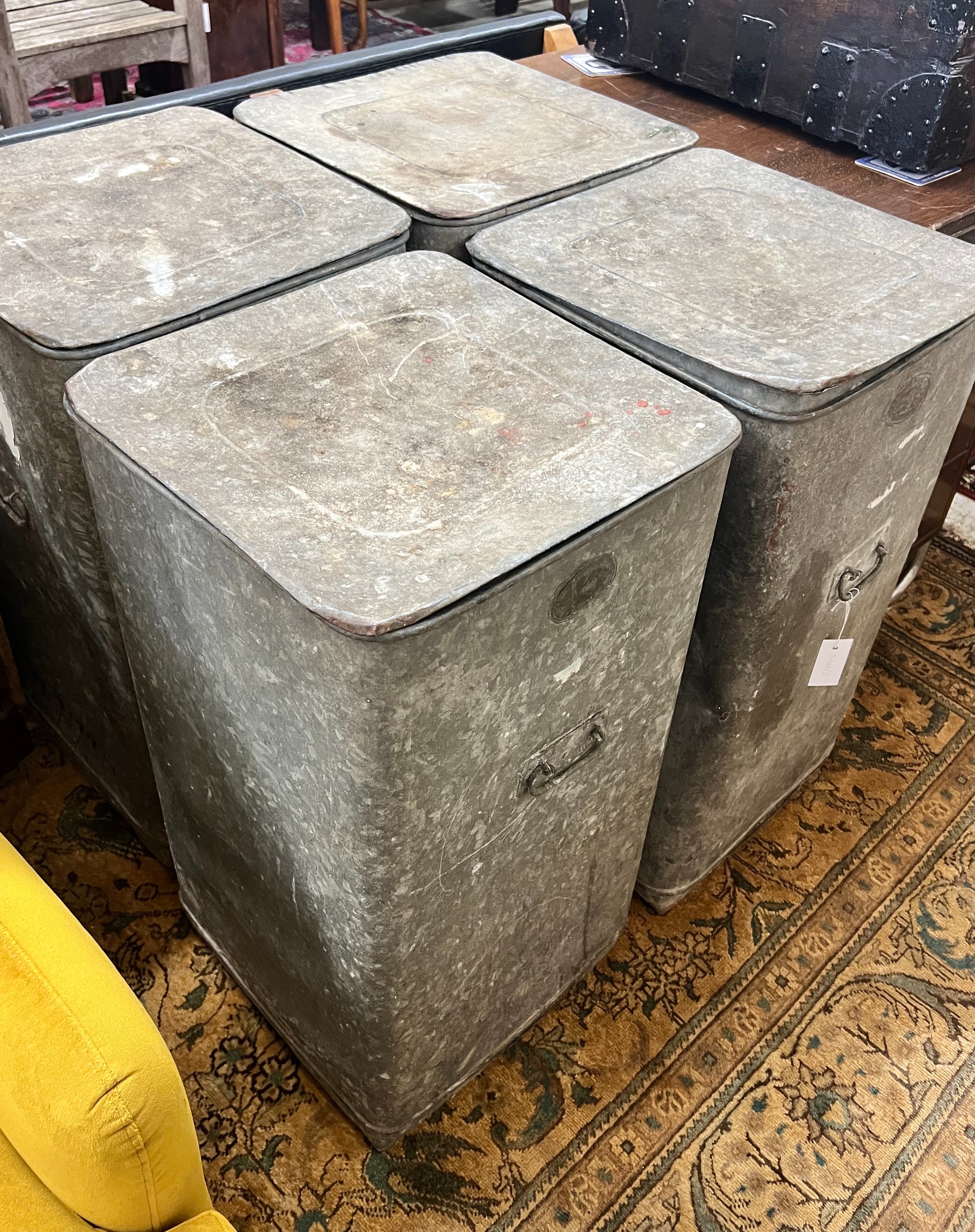 A set of four Youngs Patent galvanised grain bins with covers, width 42cm depth 42cm height 77cm